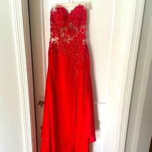 Gorgeous strapless red gown with a nude detail and touches of rhinestones